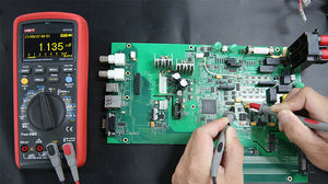 UNI-T UT171C Industrial True RMS Digital Multimeter – 60000 Count OLED, AC/DC 1000V, 10A, LoZ, Square-Wave Output, -30°C Rated, USB & Bluetooth, CAT III 1000V - with a red casing, rotary dial, and OLED screen displaying 1.135 mF while testing a circuit board.