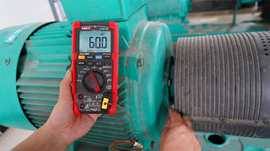 UNI-T UT17B PRO True RMS Digital Multimeter – 6000 Count, 1000V AC/DC, VFC, Temperature, Capacitance, Frequency, CAT III 1000V / CAT IV 600V, 8kV Anti-Burn - in a red and black casing, displaying 60.0 on its screen while measuring the temperature of a green industrial motor.
