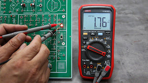 UNI-T UT18B MAX True RMS Digital Multimeter – 6000 Count, 1000V AC/DC, VFD, Temperature, LED Test, Capacitance, Frequency, EMI Protection with Gold-Plated Leads - with red casing, a digital display reading 1.76V, and gold-plated leads testing a lit red LED on a circuit board.