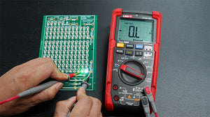 UNI-T UT18B PRO True RMS Digital Multimeter – 6000 Count, 1000V AC/DC, VFC, Temperature, LED Test, CAT III 1000V / CAT IV 600V, 8kV Anti-Burn Protection - with red and black casing, showing an "O.L" display, rotary dial, ports, and probes testing an LED circuit board.