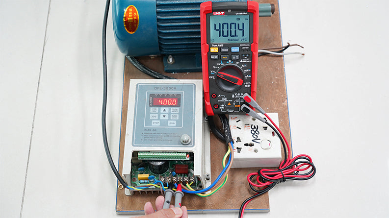 UNI-T UT18B PRO True RMS Digital Multimeter – 6000 Count, 1000V AC/DC, VFC, Temperature, LED Test, CAT III 1000V / CAT IV 600V, 8kV Anti-Burn Protection - measuring 400.4V on a motor controller, showing a red and black handheld unit with a digital display.