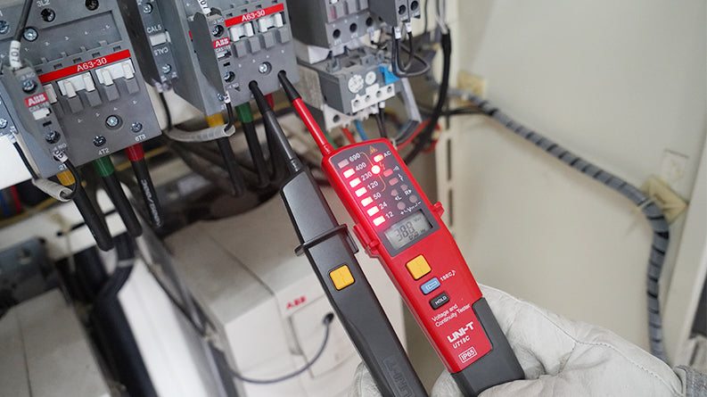 UNI-T UT18B Two-Pole Voltage & Continuity Tester – AC/DC 690V, Three-Phase Rotation, RCD Trigger, Polarity Detection, Continuity, CAT IV 600V IP65 with LED Indication - UNI-T UT18C voltage tester in a red and black casing, held by a gloved hand, showing a digital display reading 388 and illuminated LED indicators.