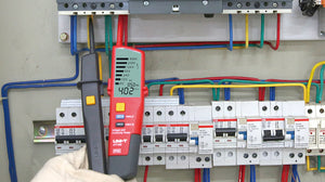 UNI-T UT18D Two-Pole Voltage & Continuity Tester with LCD Display – AC/DC 6V-690V, Frequency, Three-Phase Rotation, RCD Test, CAT IV 600V IP65 Digital Readout - red and black, held in a gloved hand against an electrical panel, showing 402V AC and 50Hz on its digital LCD screen.