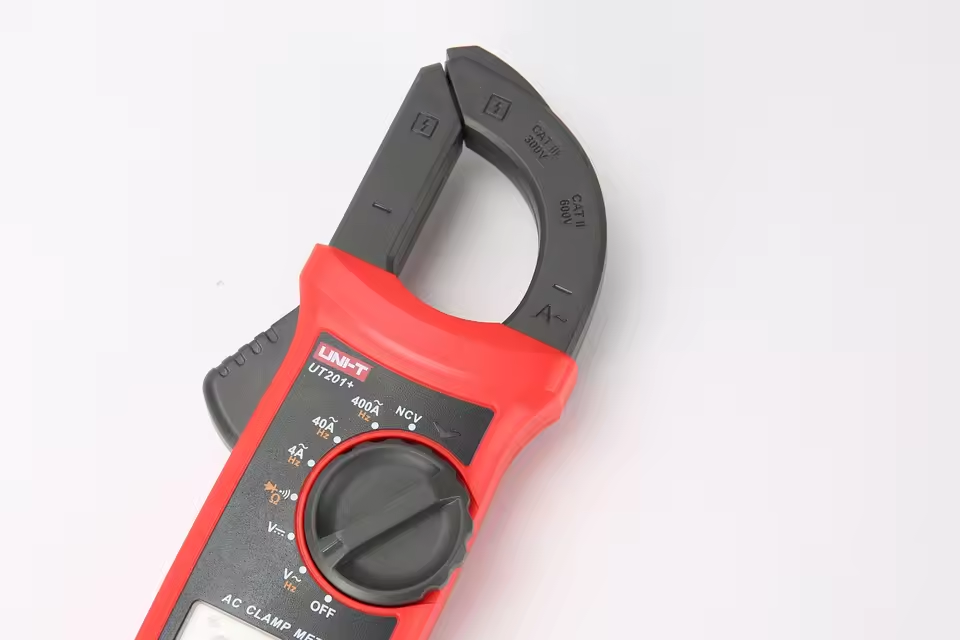 UNI-T UT201+ AC Clamp Meter True RMS 400A in Pakistan - a close-up view of the red and black plastic clamp head and the rotary function dial with various measurement settings.