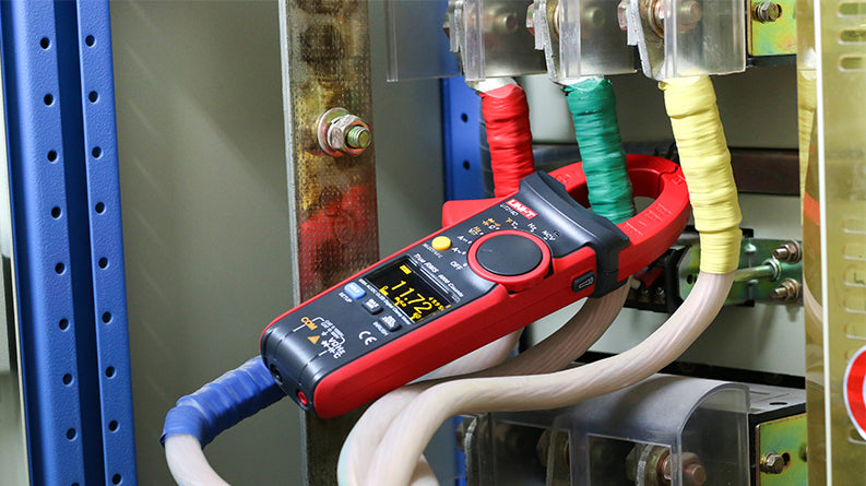 UNI-T UT216C True RMS Digital Clamp Meter – 600A AC/DC, 6000 Count, AC 750V / DC 1000V, Resistance, Capacitance, Frequency, Temperature, NCV, 30mm Jaw, CAT III 600V - clamped around a green wire, showing 11.72 on its digital display with visible control buttons.