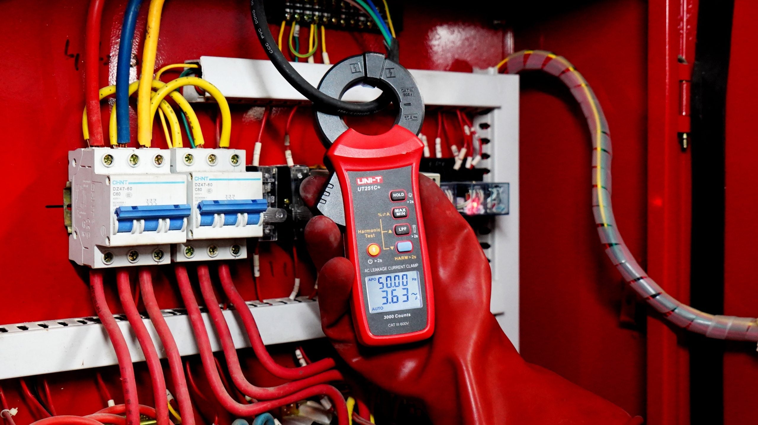 UNI-T UT251C+ AC Leakage Current Clamp Meter – 1µA Resolution, 3mA to 60A, 40mm Jaw, Harmonic Test, LPF, Bluetooth, Dual Display, CAT III 600V - a red casing, digital display reading 50.00 and 3.63, and control buttons.