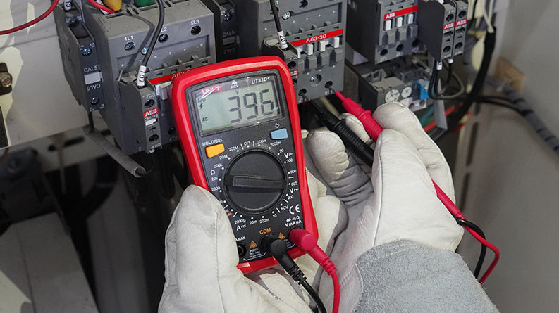 UNI-T UT33D+ Palm Size Digital Multimeter – 2000 Count, AC/DC Voltage & Current, NCV Non-Contact Detection, Resistance, Diode, CAT II 600V, 2m Drop-Proof - with a red casing, rotary dial, and LCD screen displaying 396, held by gloved hands testing electrical wiring.