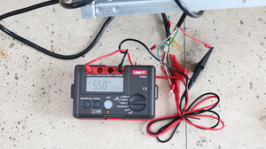 UNI-T UT502A Insulation Resistance Tester – Digital Megohmmeter, 500V/1000V/2500V - with a black and red casing, showing a digital display reading 5.50 GΩ and connected test leads.