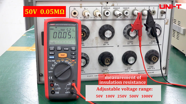 UNI-T UT505A Insulation Resistance Tester – Digital Megohmmeter - a red handheld device with a digital display showing 00.05 MΩ, connected to a resistance decade box via cables.