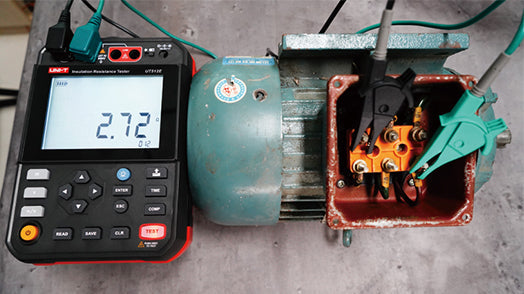 UNI-T UT512D2.5kV 2.5kV Insulation Resistance Tester – 2.5kV Digital Megohmmeter, 250V/500V/1000V/2500V - connected to an electric motor with probes, showing a 2.72 reading on the digital display.