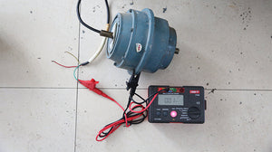 UNI-T UT526 Multifunction Electrical Tester – Multifunction Installation Tester, 250V/500V/1000V - connected to a grey cylindrical motor with red and black test leads, showing 0.01 on the digital display.