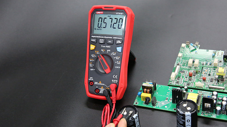 UNI-T UT61D+ True RMS Digital Multimeter – 6000 Count, AC/DC 1000V, 20A, Capacitance, Frequency, Temperature Probe, NCV, USB, CAT III 1000V / CAT IV 600V - with a red protective case, displaying 0.5720 mF on the screen, connected to a capacitor with red and black probes.