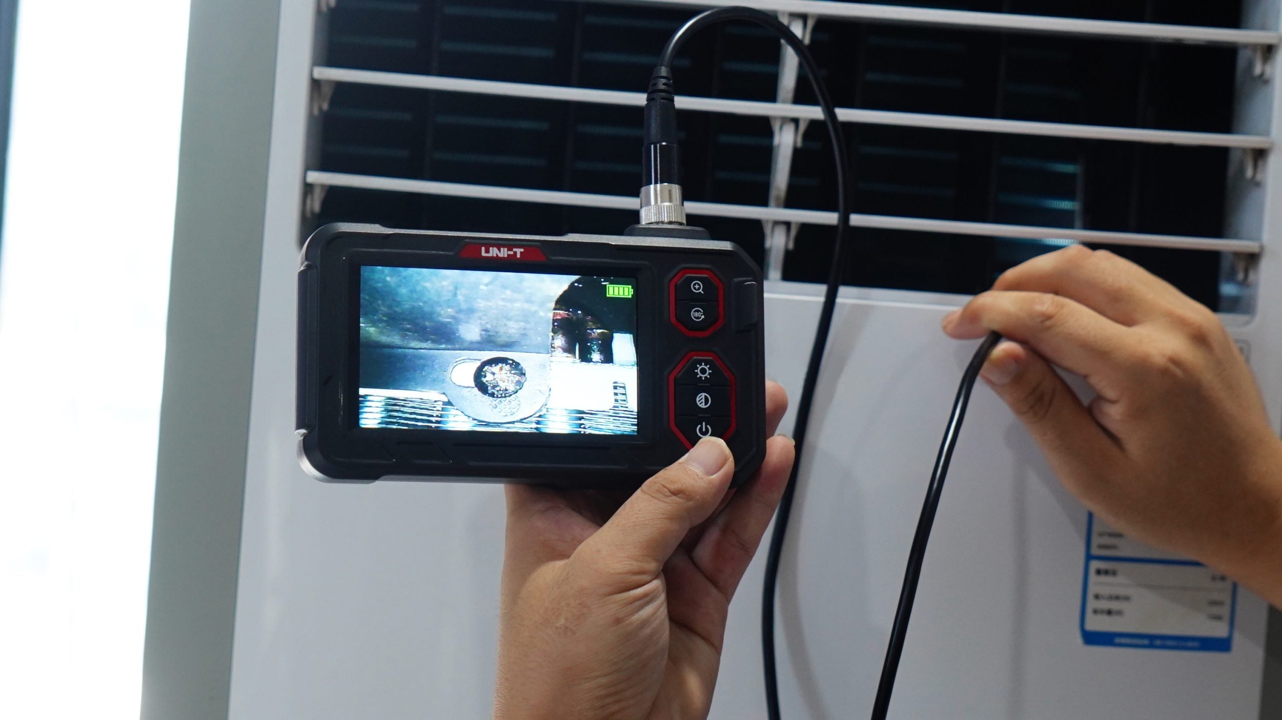 UNI-T UT667-10M Industrial Borescope – 4.3" IPS Screen, 8mm Lens, 10 m Replaceable Probe, IP67, 8 LED, Inspection Endoscope Camera - a live inspection feed on its 4.3-inch screen with controls and a connected probe cable.