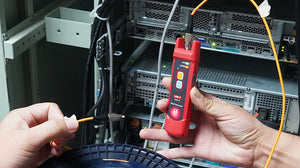 UNI-T UT691-10 Visual Fault Locator – 10mW Red Laser, 8–10km Range, 650nm, 2.5mm FC Connector, Continuous/Pulse, Rechargeable Fiber Optic VFL Pen - handheld fiber optic tester with two buttons, held by a person connecting an orange fiber optic cable.