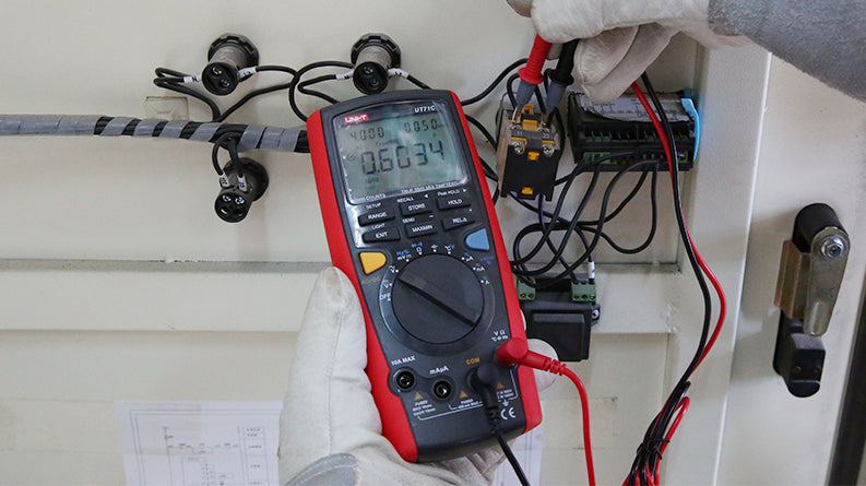 UNI-T UT71C High-Precision Intelligent True RMS Digital Multimeter – 40000 Count, AC/DC 1000V, 0.025% Accuracy, 400MHz, Temperature, USB & Bluetooth - with a red and black casing, showing a digital display reading 0.6034 while testing a component with two probes.