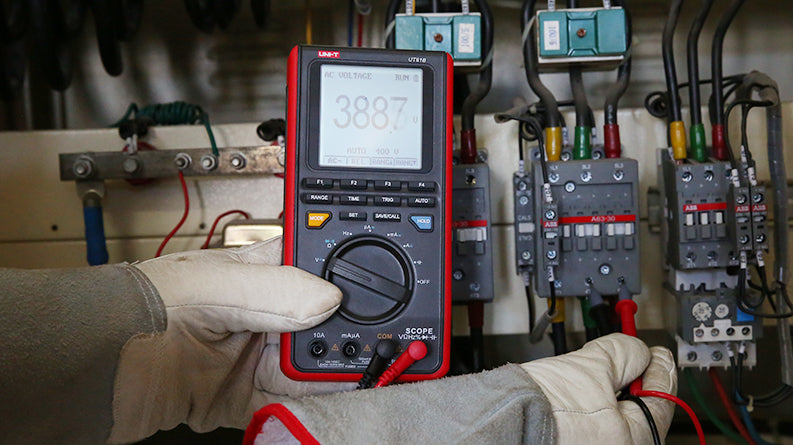 UNI-T UT81C Handheld Scopemeter – 16MHz Oscilloscope + 4000 Count Digital Multimeter, 80MS/S, AC/DC 1000V, Waveform Storage, USB, 2-in-1 Test Tool - UNI-T UT81B handheld scopemeter in a red and black case, held by a gloved hand, showing a digital display reading 388.7 V with connected test leads.