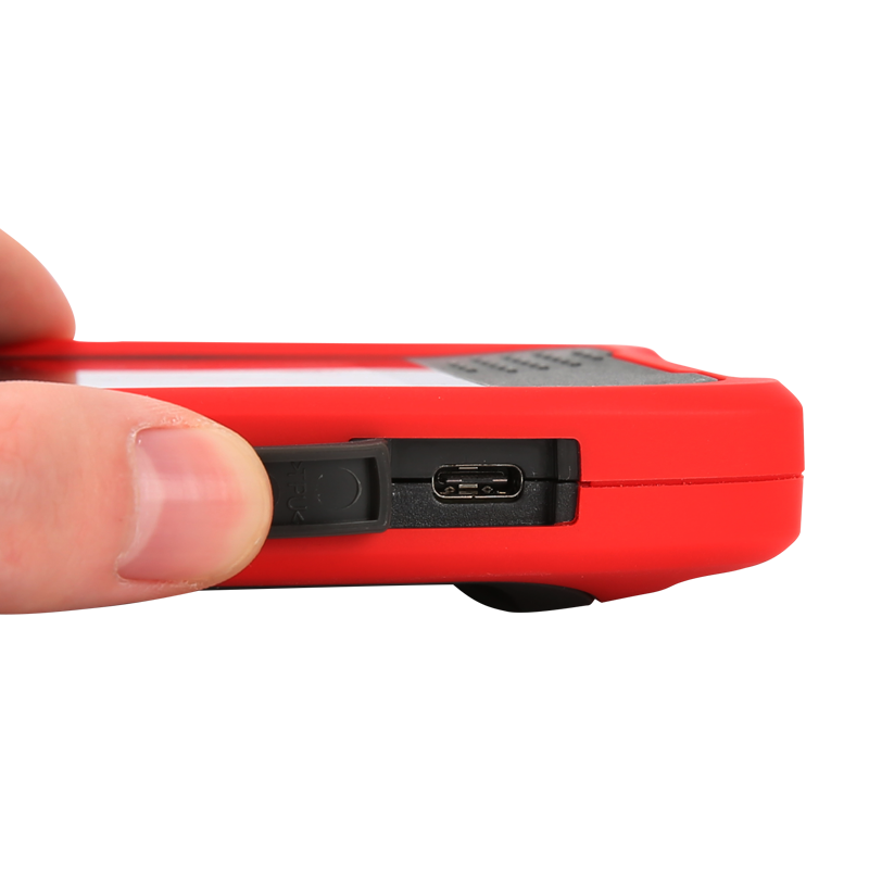 UNI-T UTI720T Portable Thermal Camera – 256×192, -20°C to 550°C, ≤50MK - close-up of a hand holding the red device to reveal an open rubber cover exposing the USB-C charging port.