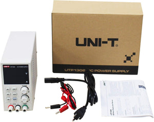 UNI-T UTP1306 Switching DC Power Supply – 192W Single Channel, 0–32V / 0–6A, 4-Digit LED, 10mV / 1mA Resolution, OVP & OCP, 3 Memory Presets - with a blank LED screen, control knobs, buttons, ports, power cable, manual, and branded box in a flat-lay arrangement.