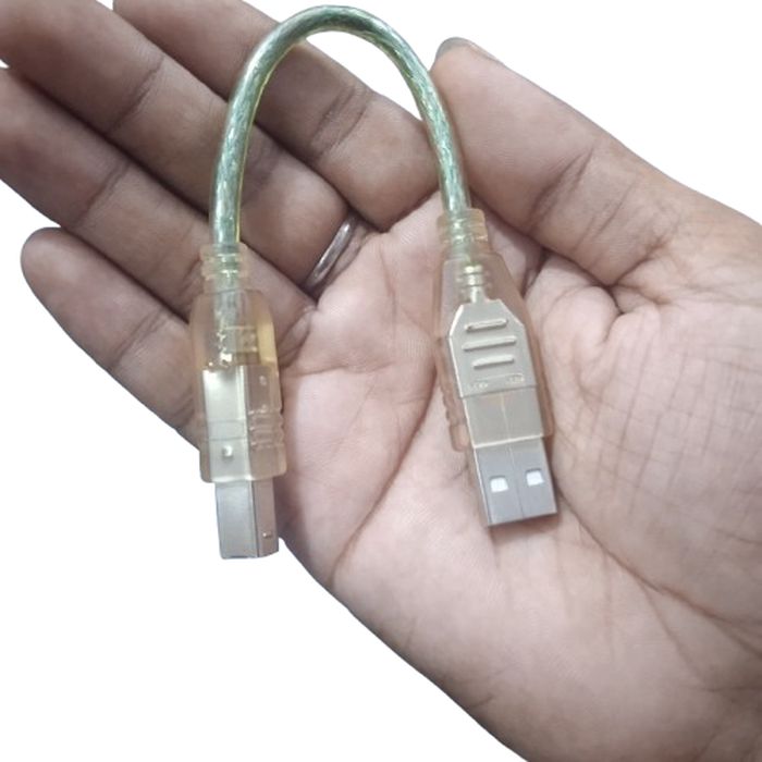 USB Cable For Arduino Uno Arduino - shown as a short, translucent USB-A to USB-B cable held in a hand.