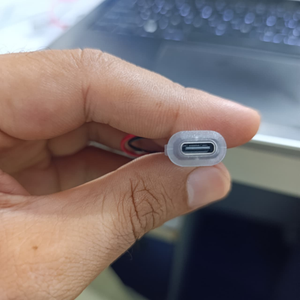 USB Type-C Oval LED Female Socket with Wires for Arduino Pakistan - close-up of a hand holding the oval-shaped USB-C port with attached red and black wires.