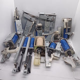 Used 1 Piece DC Solenoid Electromagnet In Mix Shape - a collection of various metal and blue plastic DC solenoid actuators with springs and levers.