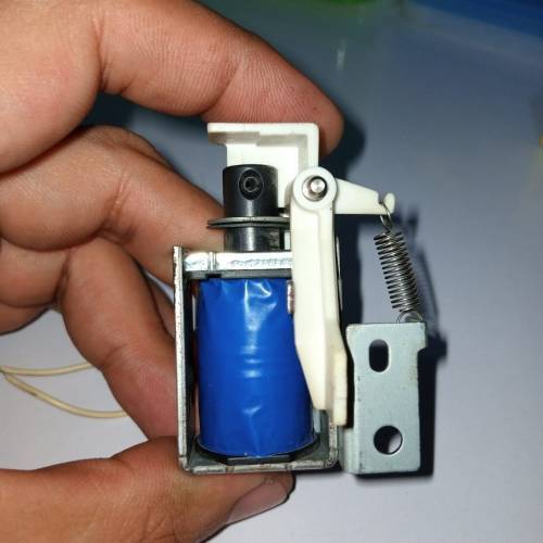 Used 1 Piece DC Solenoid Electromagnet In Mix Shape - a blue-wrapped coil, a metal frame, a white plastic lever, and a tension spring.