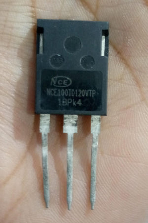 USED 1200V 100A NCE100TD120VTP Trench Fs II Fast IGBT – High-Performance Module for PV Power Systems - a black three-pin electronic component held in a hand, showing the printed model number on its face.