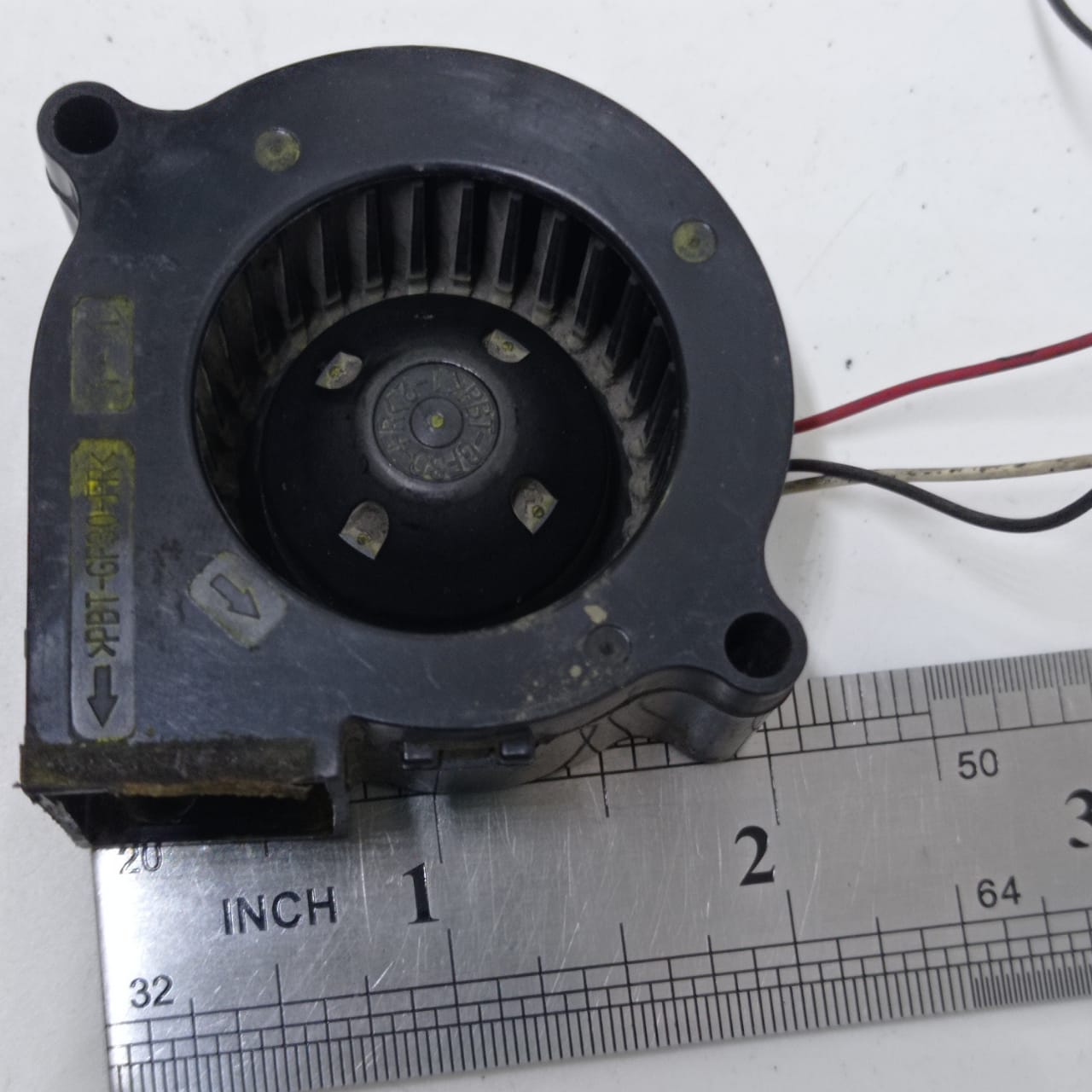 Used ≈2 Inch 24V Turbo Blower Fan Cooling Fan - a black plastic centrifugal cooling fan shown next to a metal ruler for scale.