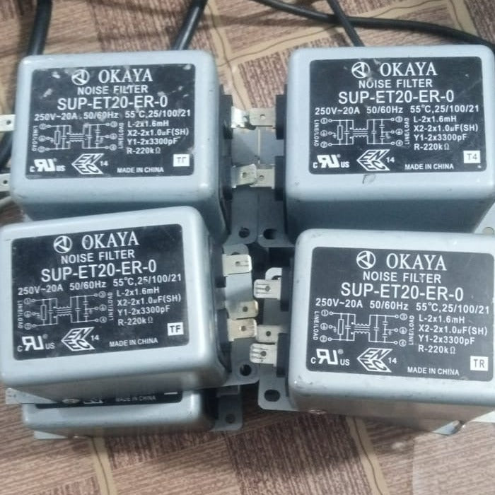 USED 20A Power Line Noise Filter - four grey, rectangular Okaya SUP-ET20-ER-0 noise filters with metal spade terminals on a patterned surface.