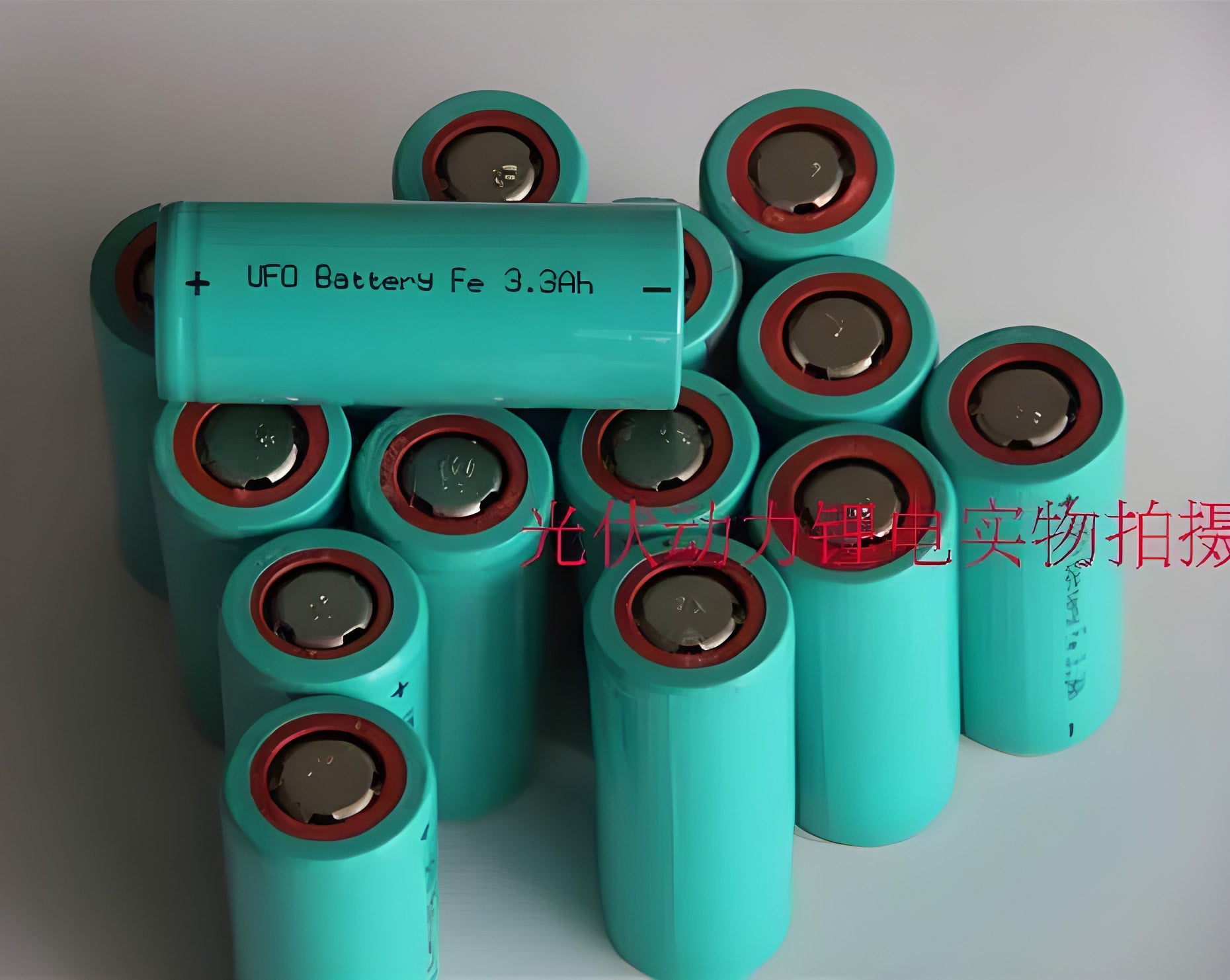 USED 26650 3.2V 3300mAh LiFePO4 Cylindrical Li-ion Batteries - shown as a pile of teal-coloured cylindrical cells with red rings around the top terminals.