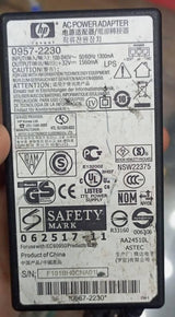 Used 32V Adapter Power Supply With 220V Power Cable - a rectangular black power brick showing a detailed technical specification label with HP branding and various safety symbols.