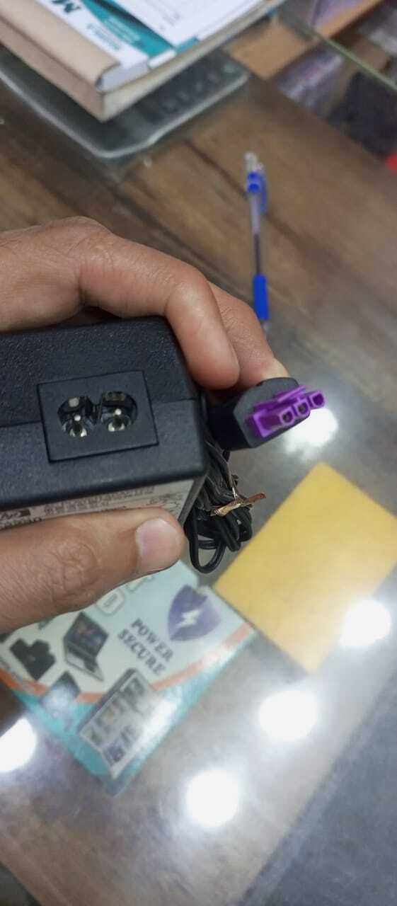 Used 32V Adapter Power Supply With 220V Power Cable - a close-up of the black adapter brick and its purple-accented power connector cable.