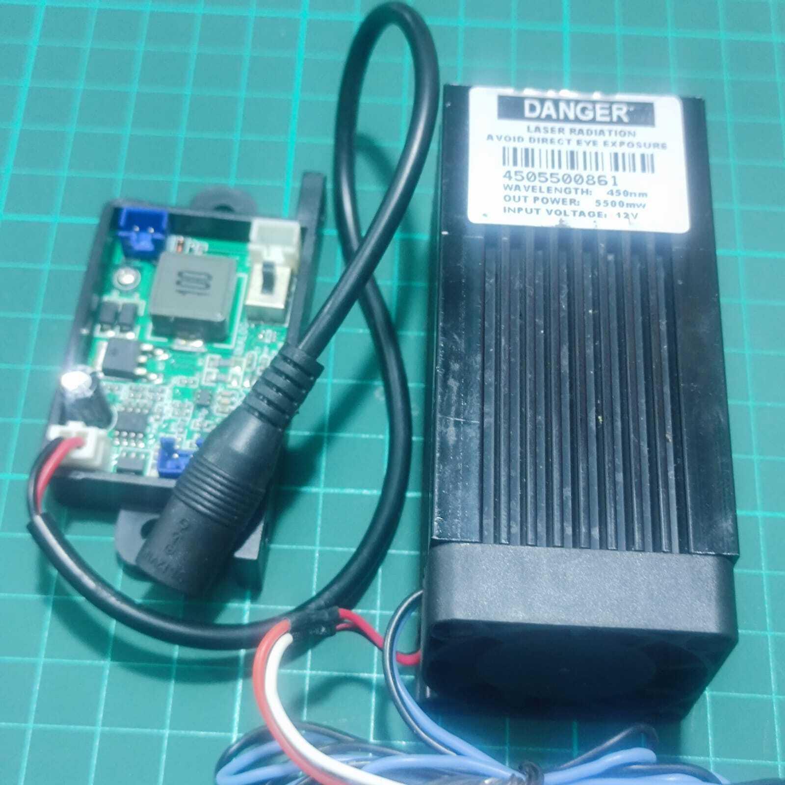 Used 5500mW Laser Module 450nm Blue Laser Head Engraving Cutting Laser Kit 5.5W Laser - a black laser head with a cooling fan and a green circuit board controller connected by a black cable.