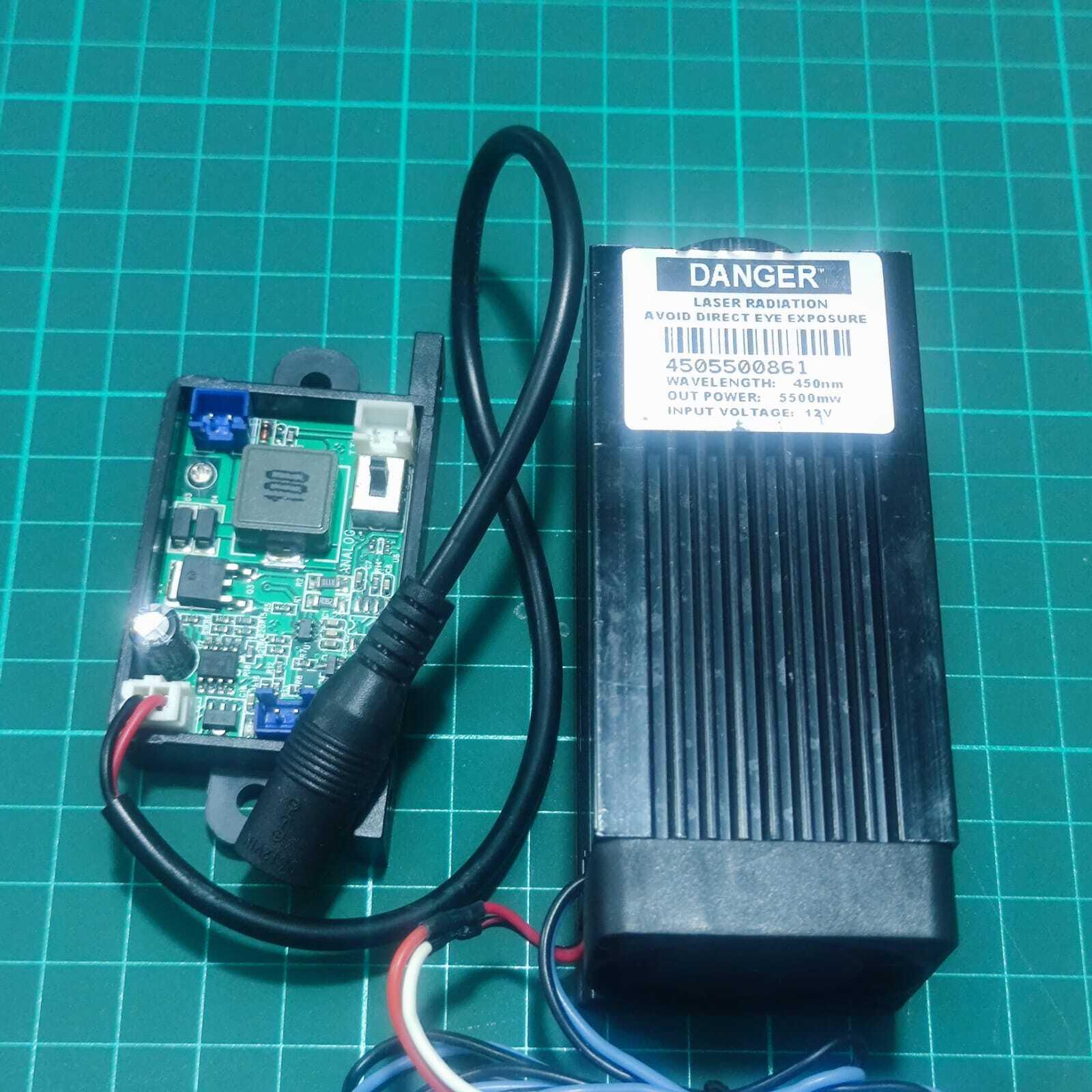 Used 5500mW Laser Module 450nm Blue Laser Head Engraving Cutting Laser Kit 5.5W Laser - a black rectangular laser head with a danger label and a green circuit board with ports and cables.