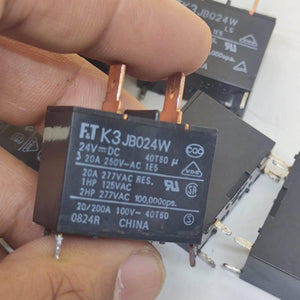 USED Fujitsu Japan JB024W 24V 20A Relay Switch High Current Relay POWER RELAY - a black rectangular power relay with metal contact pins held in a hand, showing printed technical specifications.