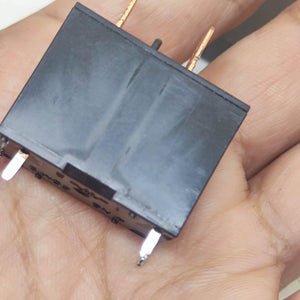 USED Fujitsu Japan JB024W 24V 20A Relay Switch High Current Relay POWER RELAY - a black rectangular electronic component with four metallic pins held in a hand.