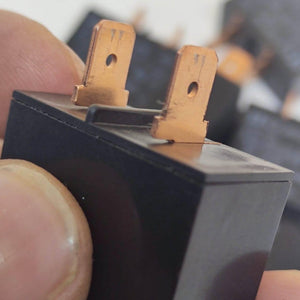 USED Fujitsu Japan JB024W 24V 20A Relay Switch High Current Relay POWER RELAY - a close-up view of the black rectangular housing with two copper-colored metal spade terminals on top.