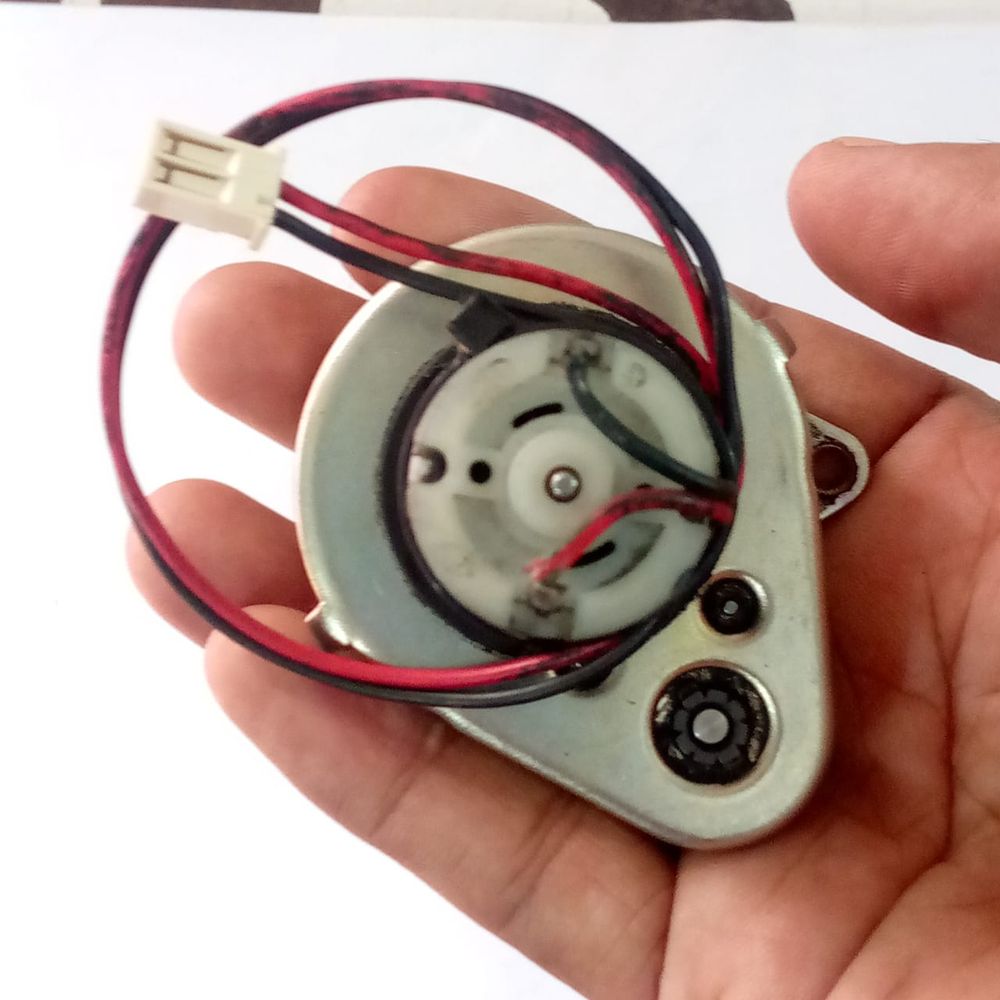 Used High Torque Gearbox Motor SP2688 Xerox 5855 Web Supply Motor - shown held in a hand with a two-pin white connector and attached red and black wires.