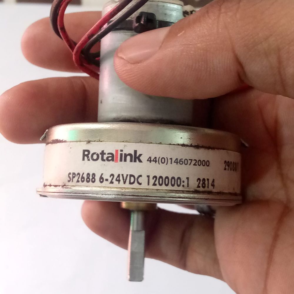 Used High Torque Gearbox Motor SP2688 Xerox 5855 Web Supply Motor - a silver cylindrical motor with a gearbox, held in a hand with wires visible at the top and a flat-sided shaft.