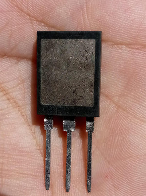Used IGBT 650V 160A High IGBT Q160V65SDB1A - a close-up of a black, rectangular three-pin electronic component held in a hand.