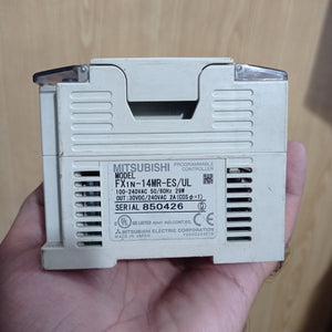 Used Mitsubishi PLC Fx1n-14MR-ES/UL - the front label with model details, power specifications, and serial number on a beige plastic case.