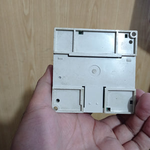 Used Mitsubishi PLC Fx1n-14MR-ES/UL - a close-up of the plain white plastic back panel featuring recessed mounting areas and a central circular indentation.
