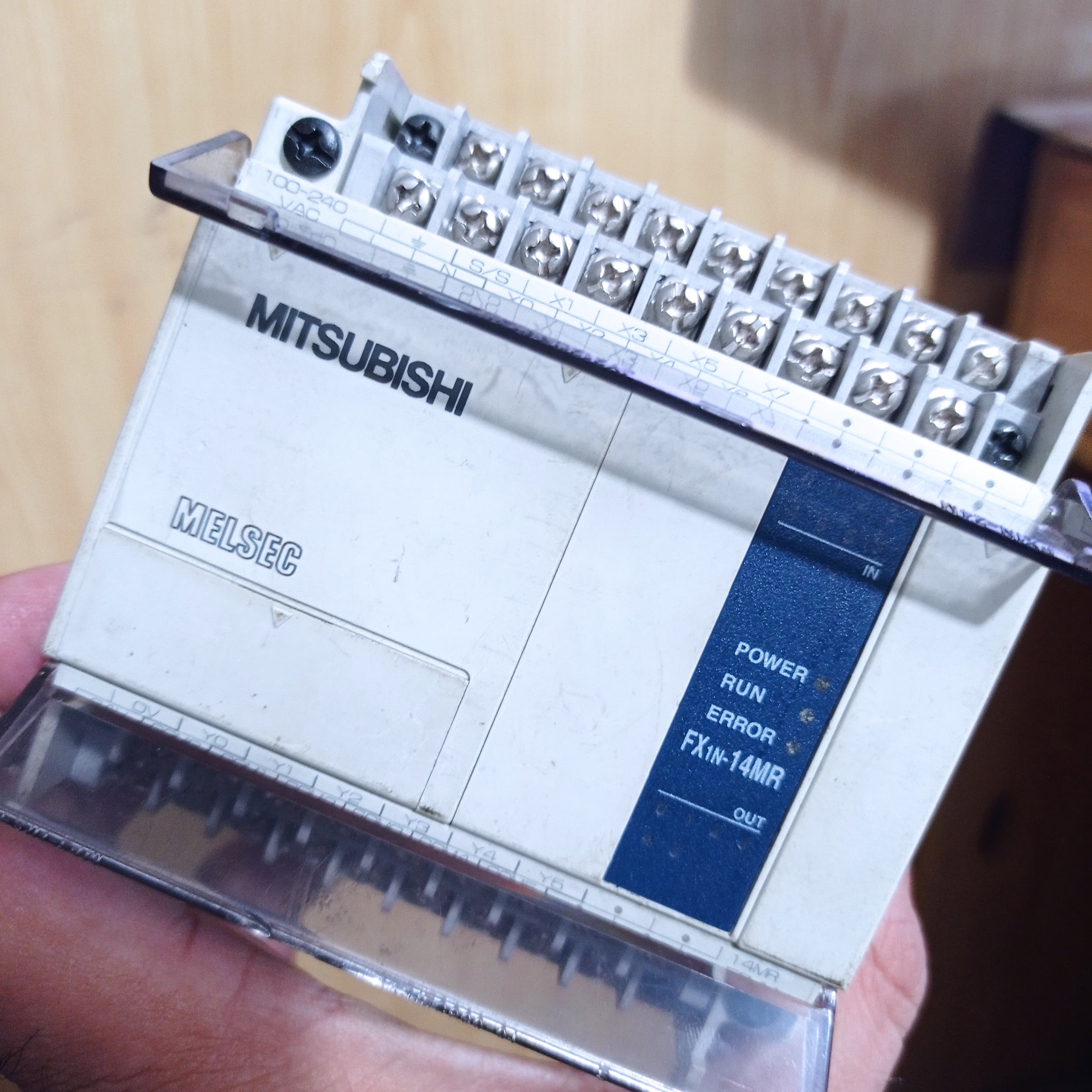 Used Mitsubishi PLC Fx1n-14MR-ES/UL - a white rectangular industrial control unit with visible screw terminals, input/output labels, and status indicator lights.