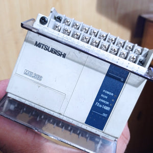Used Mitsubishi PLC Fx1n-14MR-ES/UL - a white rectangular industrial control unit with visible screw terminals, input/output labels, and status indicator lights.