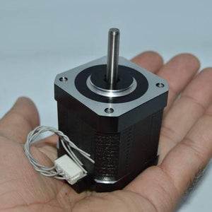 Used NEMA 17 4.2 Kg-cm Stepper Motor For CNC And 3d Printer - shown as a black square motor with a silver shaft and a white wire connector in a hand.