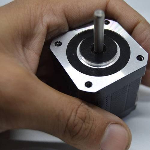 Used NEMA 17 4.2 Kg-cm Stepper Motor For CNC And 3d Printer - a close-up shot showing a hand holding the black and silver square motor with its central metal shaft.