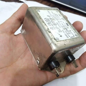 Used Noise Filter EMI Filter Anti-Interference Noise Signal Filtration Single Phase Mains Filter 125V 250V - held in a hand, showing the silver metal casing, a printed label with specifications, and two black electrical terminal connectors.