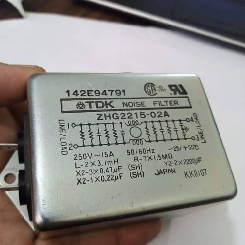 Used Noise Filter EMI Filter Anti-Interference Noise Signal Filtration Single Phase Mains Filter 125V 250V - TDK Noise Filter ZHG2215-02A, a rectangular silver EMI filter held in a hand, showing its wiring diagram, specifications, and terminal connectors.