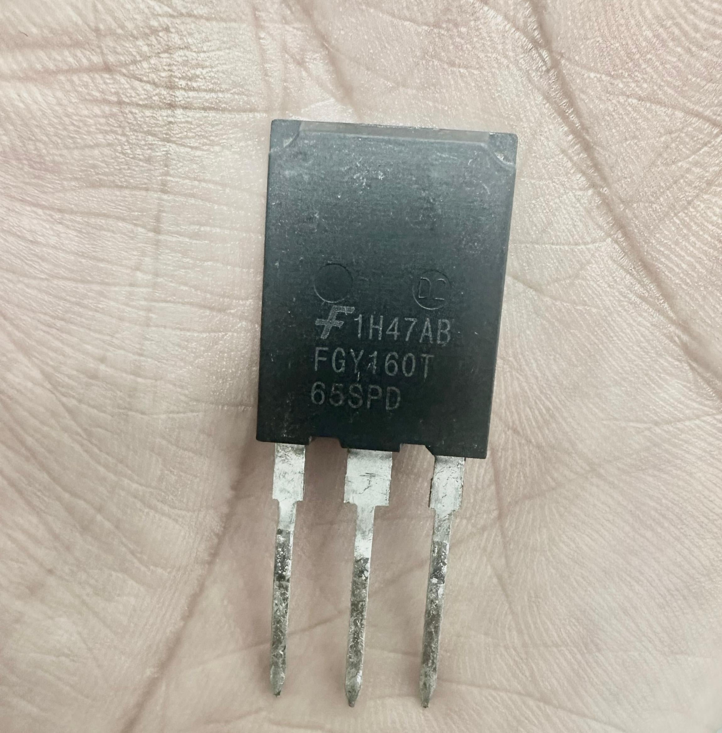 USED Onsemi 160A 650V FGY160T65SPD Onsemi IGBT-Digilog.pk - a black three-pin electronic component held in a hand with the model number printed on the front.