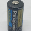 USED Product Panasonic Industrial CR123A Lithium Battery - black cylindrical battery with blue and yellow branding, shown from a slightly elevated angle.